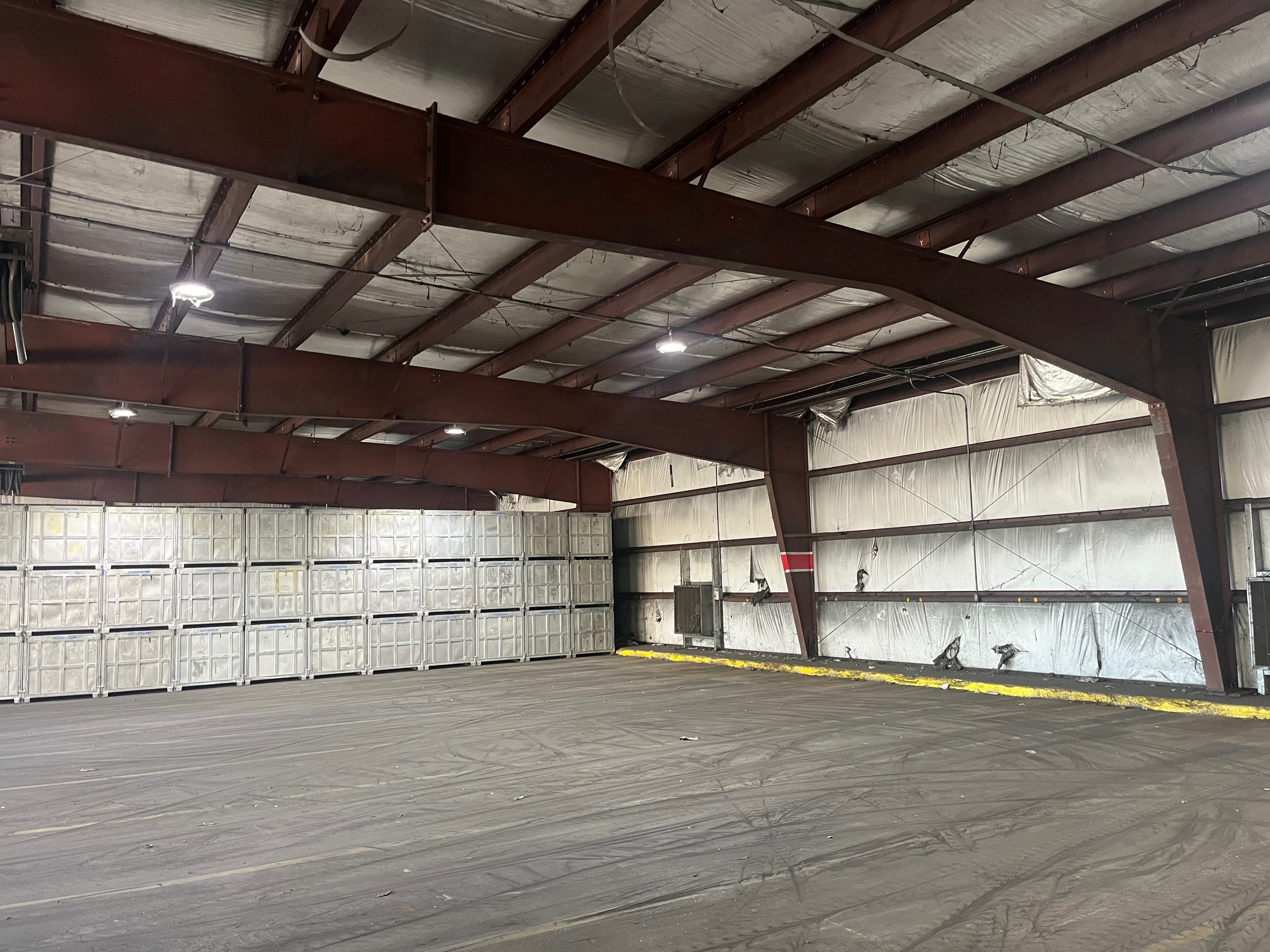 Large warehouse interior with complete bird netting installation